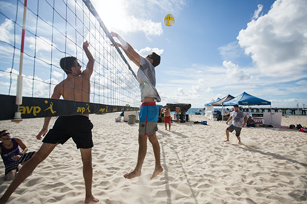 men playing sand volleyball