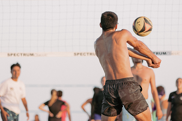 man playing sand volleyball