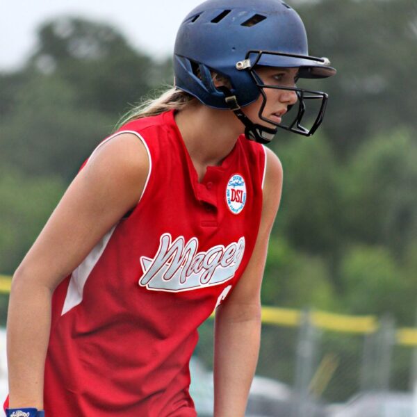 a girl with a batting helmet and red jersey
