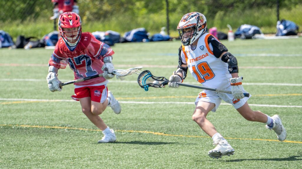 two kids playing lacrosse